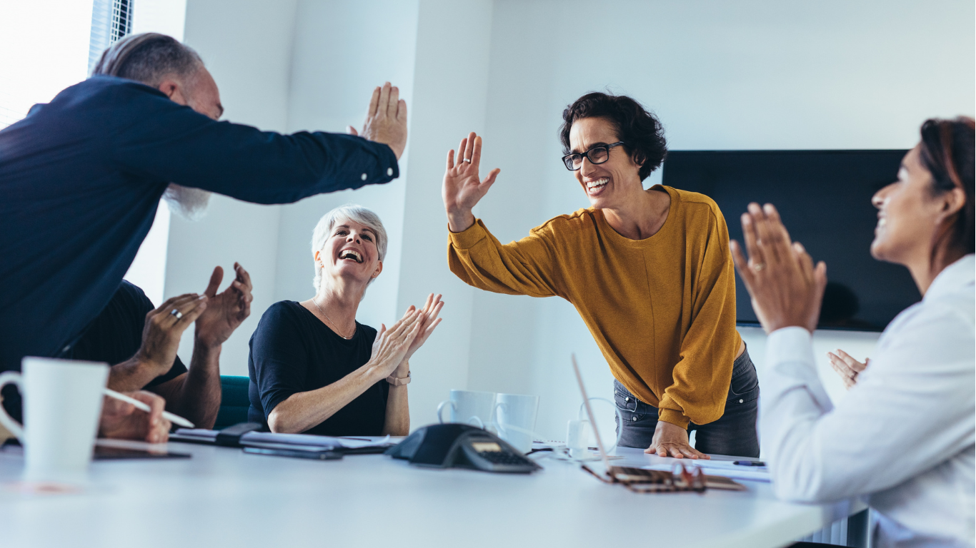 A growing team celebrating a successful hiring milestone